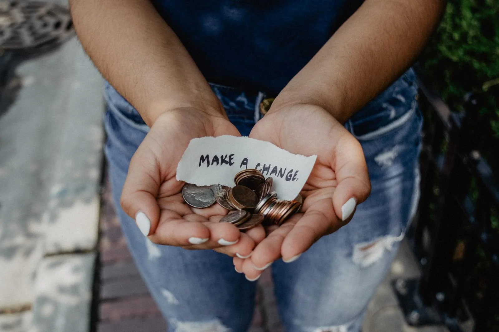 Hands holding a collection of coins
